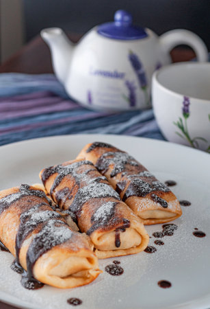 Pancakes with chocolate and a cup of teaの写真素材