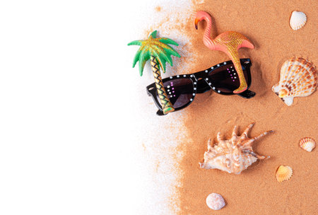 sunglasses and seashells on yellow sandの写真素材