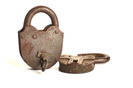 two antique iron padlocks with key isolated on white background.の写真素材