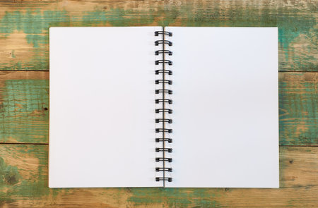 open white notebook on wooden backgroundの写真素材
