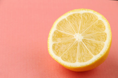half lemon on coral background. citrus fruit on living coralの写真素材