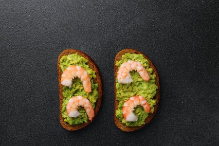 shrimp and guacamole with bread on dark backgroundの写真素材