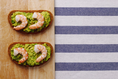 shrimp and avocado on bread with light background healthy breakfastの写真素材