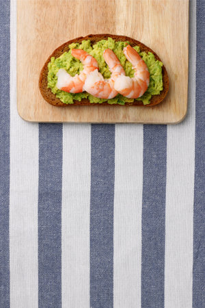 sandwich with shrimp and avocado on wood. breakfast conceptの写真素材