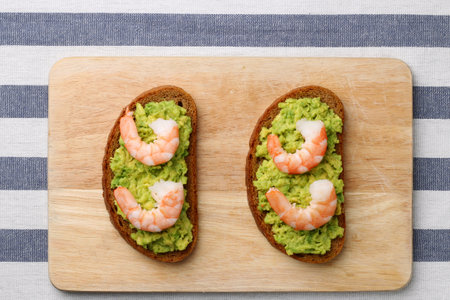 sandwich with shrimp and avocado on wood. breakfast conceptの写真素材