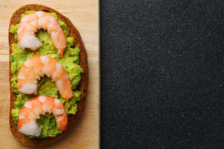 shrimp and guacamole with bread on dark backgroundの写真素材