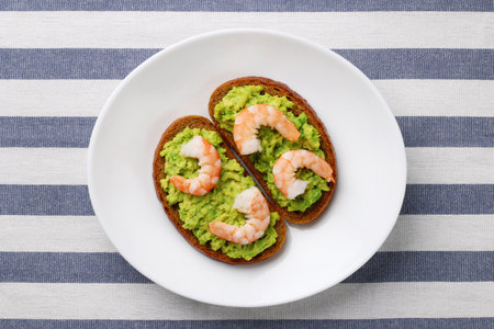 sandwich with avocado guacomole and srimp on plateの写真素材
