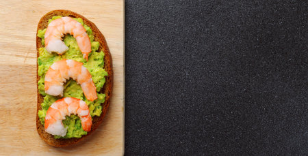 shrimp and guacamole with bread on dark backgroundの写真素材
