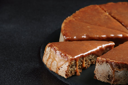 pie with caramel close up on dark background. cake with banana and caramelの写真素材