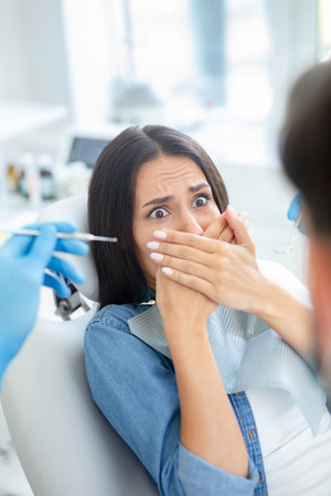 client is afraid of dentist in dental officeの写真素材