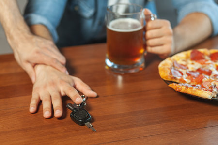 man holding hand of his drunk friend with car keys
