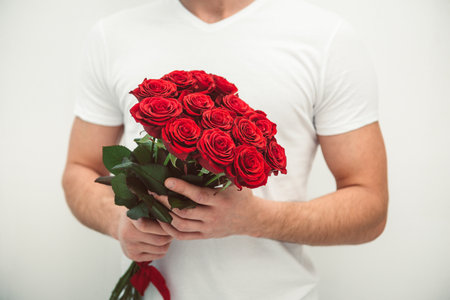 man holding bouquet of red roses, valentines day conceptの写真素材