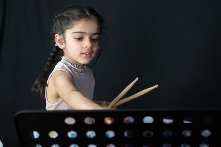 5 year old practices on the drums.の写真素材