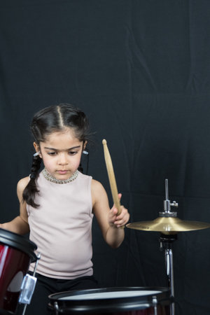 5 year old practices on the drums.の写真素材