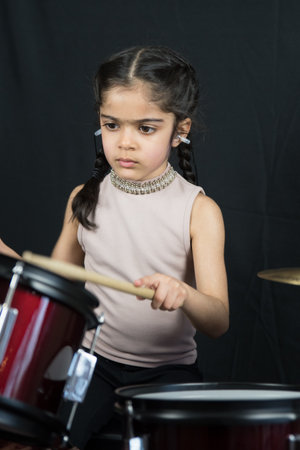 5 year old practices on the drums.の写真素材