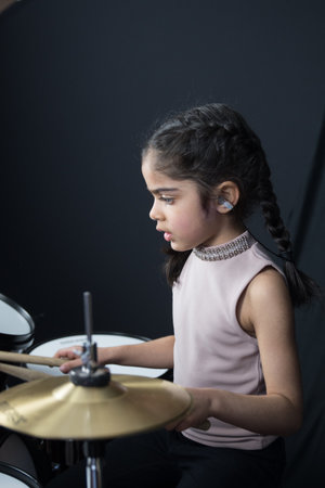 5 year old practices on the drums.