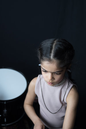 5 year old girl practices the drums.の写真素材