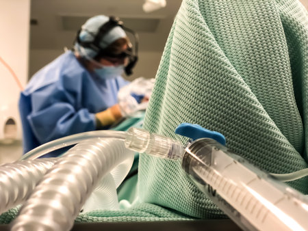 View of surgeon in the background - selective focus - with syringe and intravenous line in the foreground.の写真素材