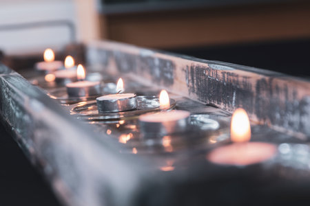 Row of tea lights on a rustic wooden tray on Diwali.