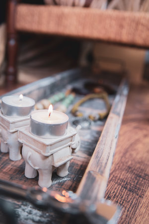 Row of tea lights on a rustic wooden tray on Diwali.の写真素材