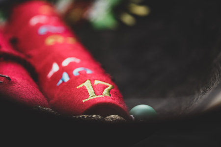 Advent calendar with dates - small red tubs - next to a miniature Christmas tree.rの写真素材