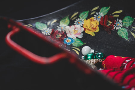 Iron tray with red handles and Christmas baubles.