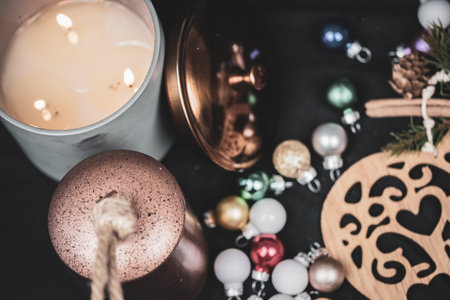 Christmas themed articles around a candle flame - background, copy space.