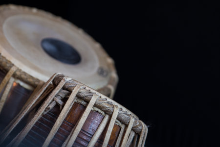 Images of a man's hands (wearing beads) playing the Tabla - Indian classical music percussion...