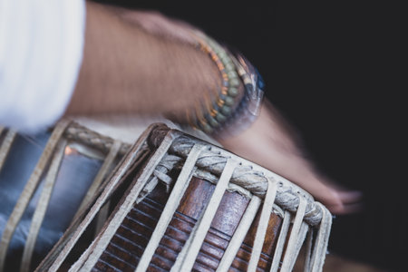 Images of a man's hands (wearing beads) playing the Tabla - Indian classical music percussion...