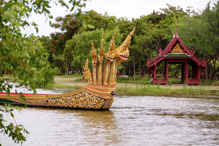 BANGKOK, THAILAND Ancient Siam Ancient City, Mueang Boran park, Royal decorated wooden thai boat on pond.の写真素材