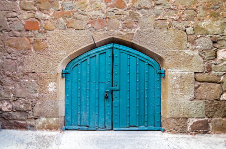 An old wood door decorated with carvingの写真素材