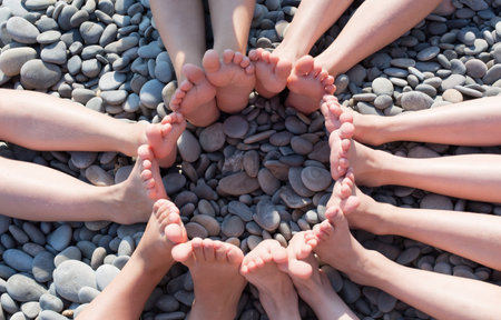 Feet figure a circle on the beach.の写真素材
