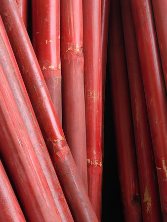 Stack of Red Bamboo Sticks with Weathered Surface.の写真素材