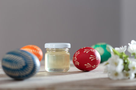 Painted easter eggs composition with spring honey and cherry flower