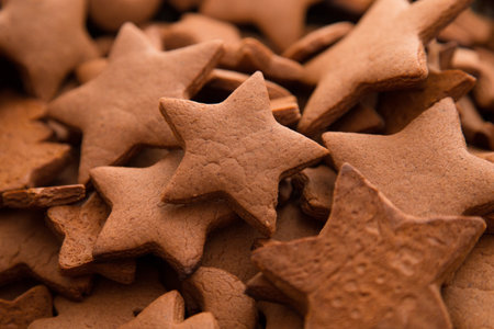 Christmas gingerbread cakes in shape of stars on rustic wooden table.の写真素材