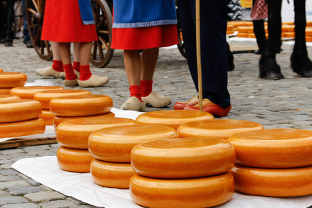Young woman legs in wooden dutch shoes on a old town cheese market in Gouda, Hollandの写真素材