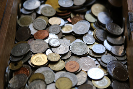 Coins mixed collection, gathered in a wooden box.の写真素材