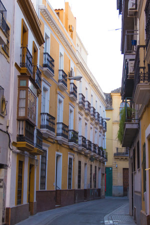 Building in Seville, Spain, details of old facade, wall with wooden frame windows.の写真素材