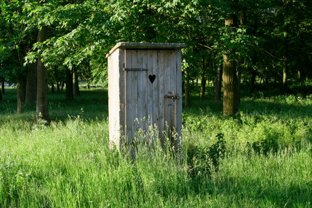Old fashioned toilet building with wooden door.の写真素材