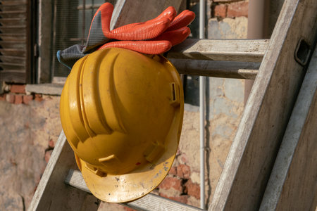 Helmet and protective gloves on a construction site, close-upの写真素材