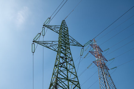 high voltage electricity pylon, a symbol of energy and infrastructure. the iconic and functional metal structure, a symbol of technological progress, supplies the life-giving current to cities.の写真素材