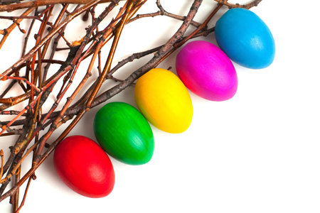 Colored Easter eggs from the branches. On a white background.の写真素材