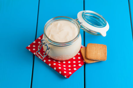 Homemade yogurt on a blue wooden table. Healthy breakfast.の写真素材