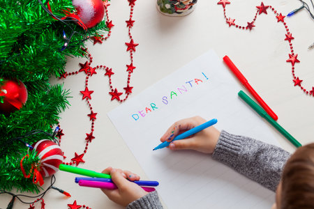 Children writing letter to Santa Claus at Christmas. Top view.の写真素材