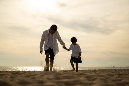 Happy Asian family travel on beach on holidayの写真素材