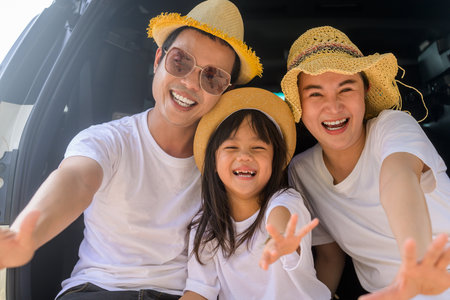Happy Asian family travel on beach on holidayの写真素材