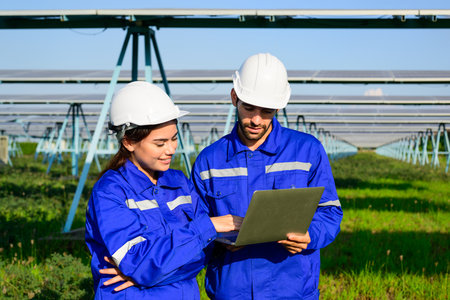 Workers installing solar panels, Engineer team at solar panel farm