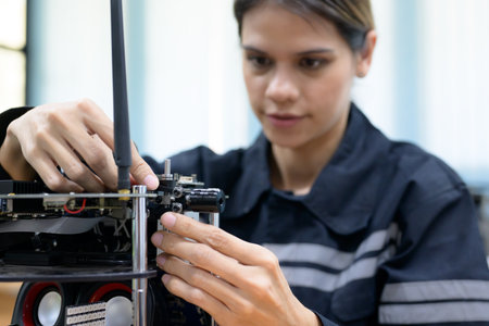 Female maintenance engineer checking and repairing automatic robotic machineの写真素材