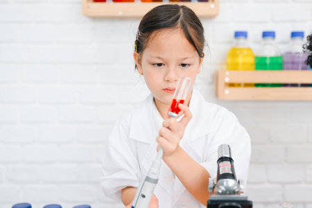 Child in classroom at school, Kid dressed Science lab coat. Science conceptの写真素材