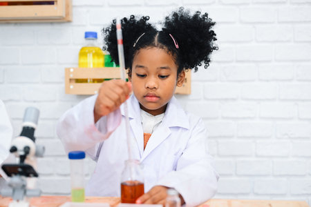 Child in classroom at school, Kid dressed Science lab coat. Science conceptの写真素材